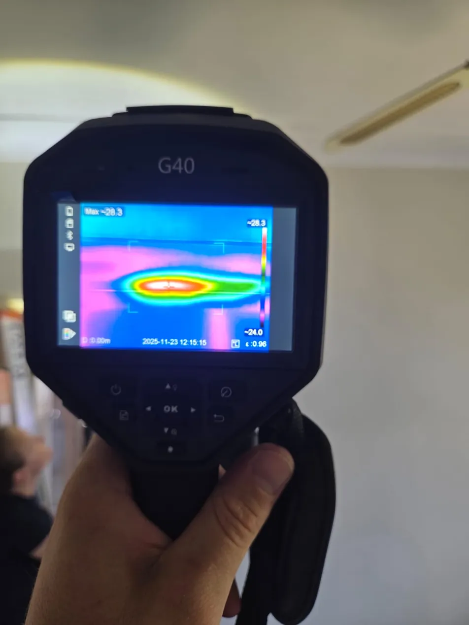 Thermal camera showing heat anomaly in building ceiling